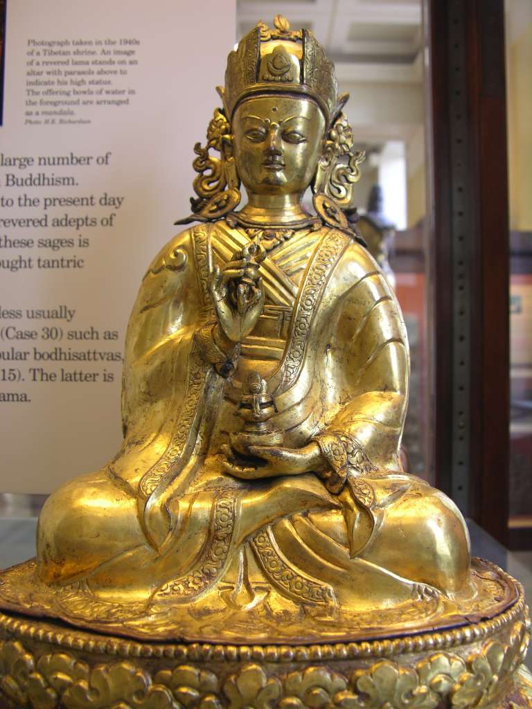 British Museum Top 20 Buddhism 19 Padmasambhava 19. Padmasambhava  Tibet, 18C AD, 38 cm high. Padmasambhava (Tib. Guru Rinpoche) is revered for bringing Tantric Buddhism to Tibet from northern India in the late 8C AD. The gilt bronze figure is shown seated on a lotus throne in the rich robes of a prince. He holds a vajra in his right hand and in his left a vase of the elixir of immortality.